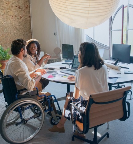 Three people in discussion during a meeting