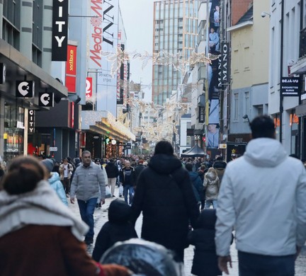 People walking down a busy shopping street in Den Haag, Netherlands